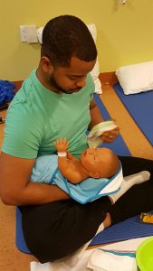 Dad learning how to bathe baby