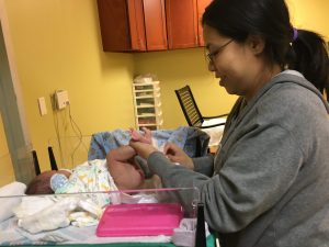 Mom changing baby's diaper